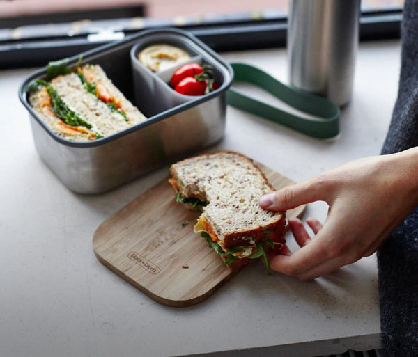 Sandwich with bite out of it in Black and Blum stainless steel lunch box